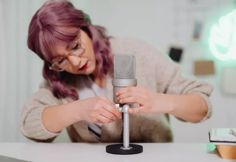 Lady setting up microphone for audio